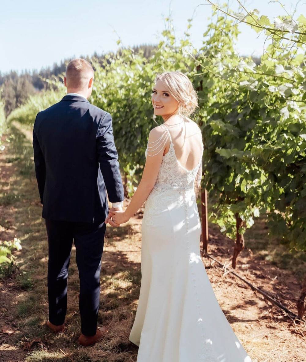 Сouple wearing a white gown and a black suit
